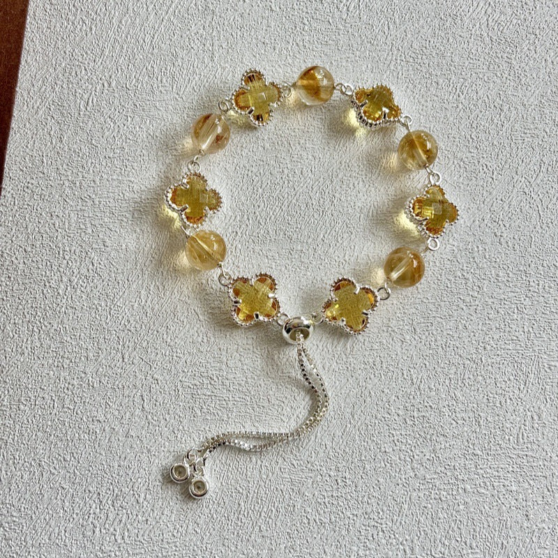 Close-up of Citrine and Golden Tiger's Eye gemstones in a four-leaf clover bracelet design