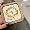 Joyceen Golden Clover Crystal Bracelet featuring natural Citrine and Golden Tiger's Eye gemstones with four-leaf clover charms