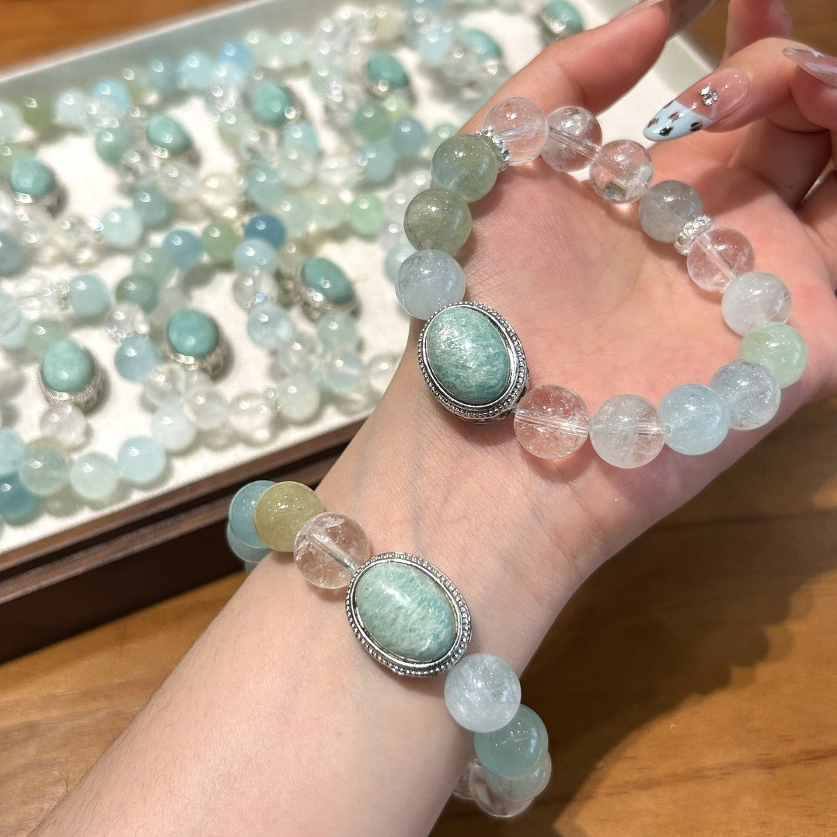 Woman wearing an ocean blue crystal bracelet featuring natural Aquamarine and Amazonite gemstones