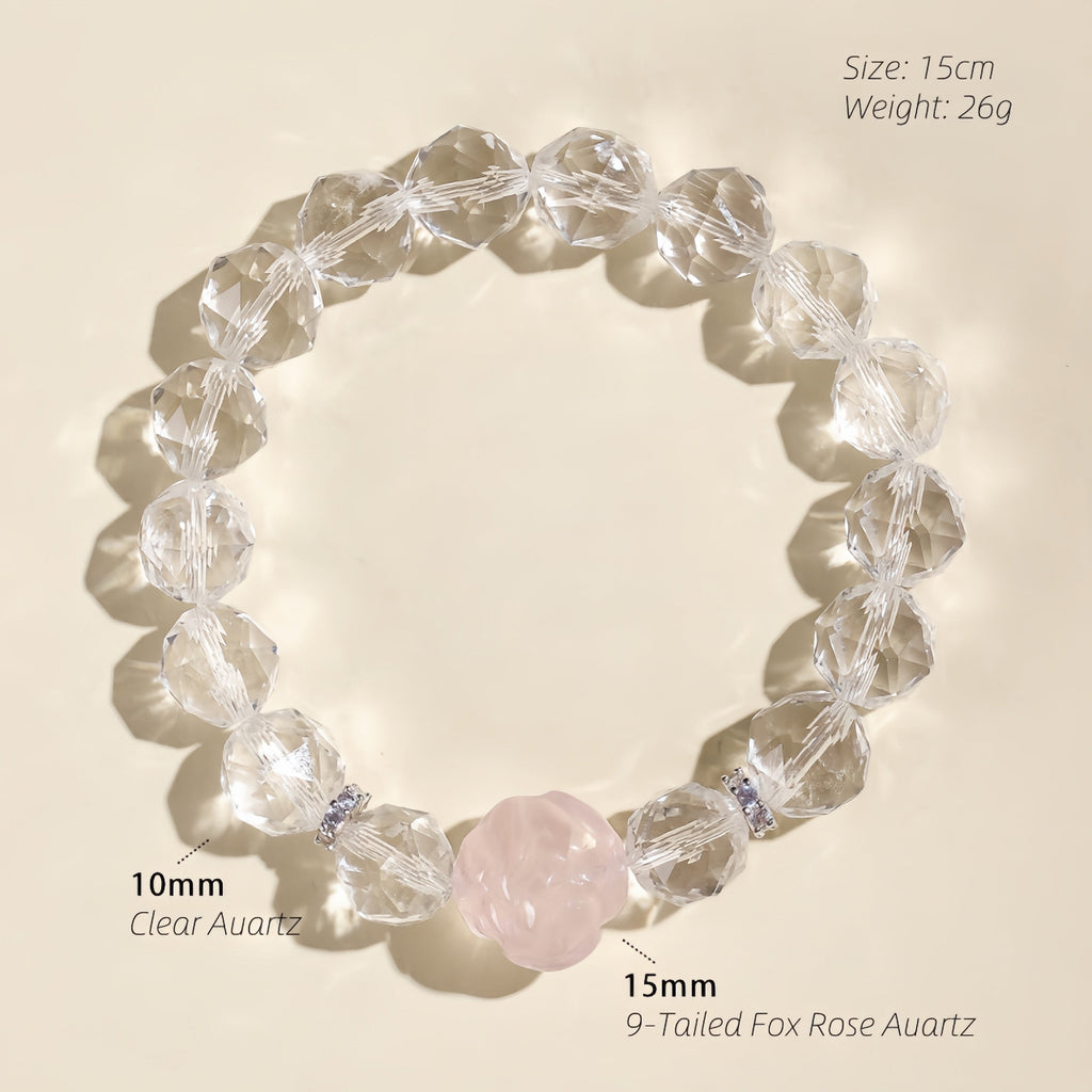 Close-up of a carved Rose Quartz fox charm surrounded by natural Clear Quartz gemstone beads