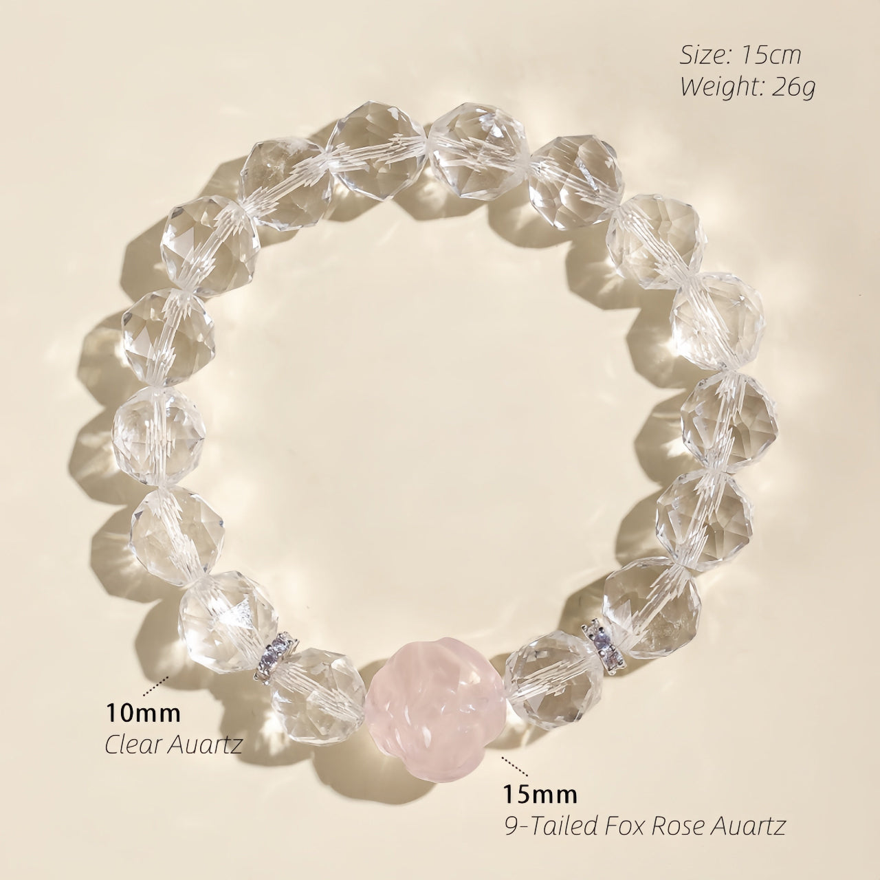 Close-up of a carved Rose Quartz fox charm surrounded by natural Clear Quartz gemstone beads
