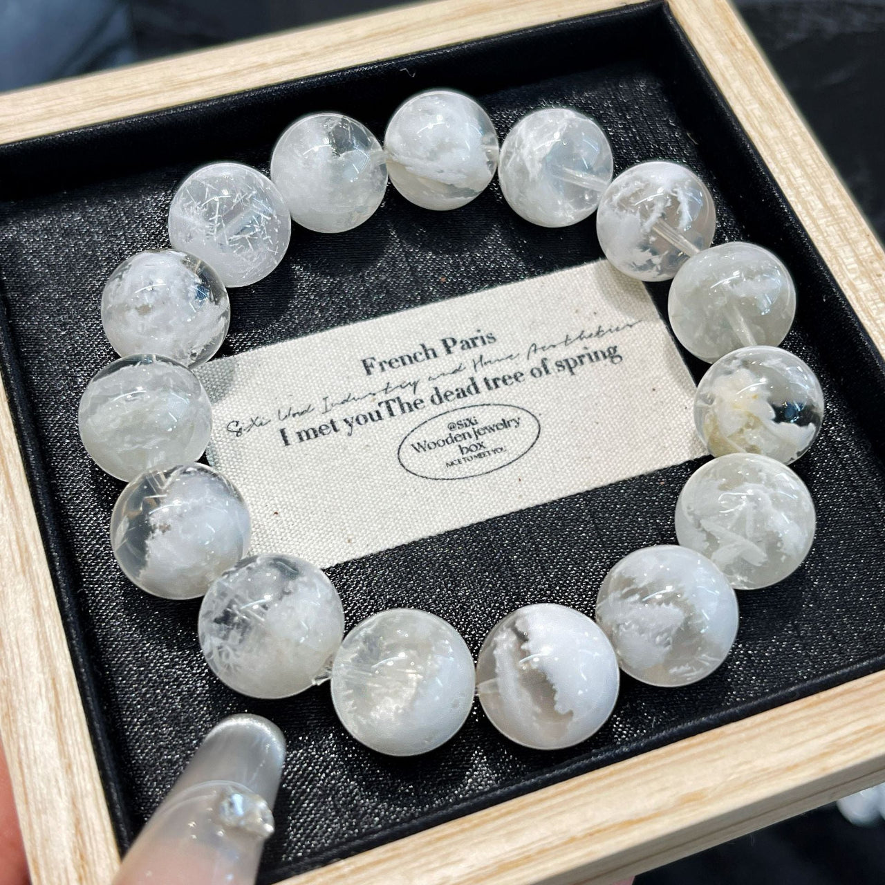 Close-up of natural Snow Phantom Quartz beads showcasing unique snowy inclusions and crystal clarity