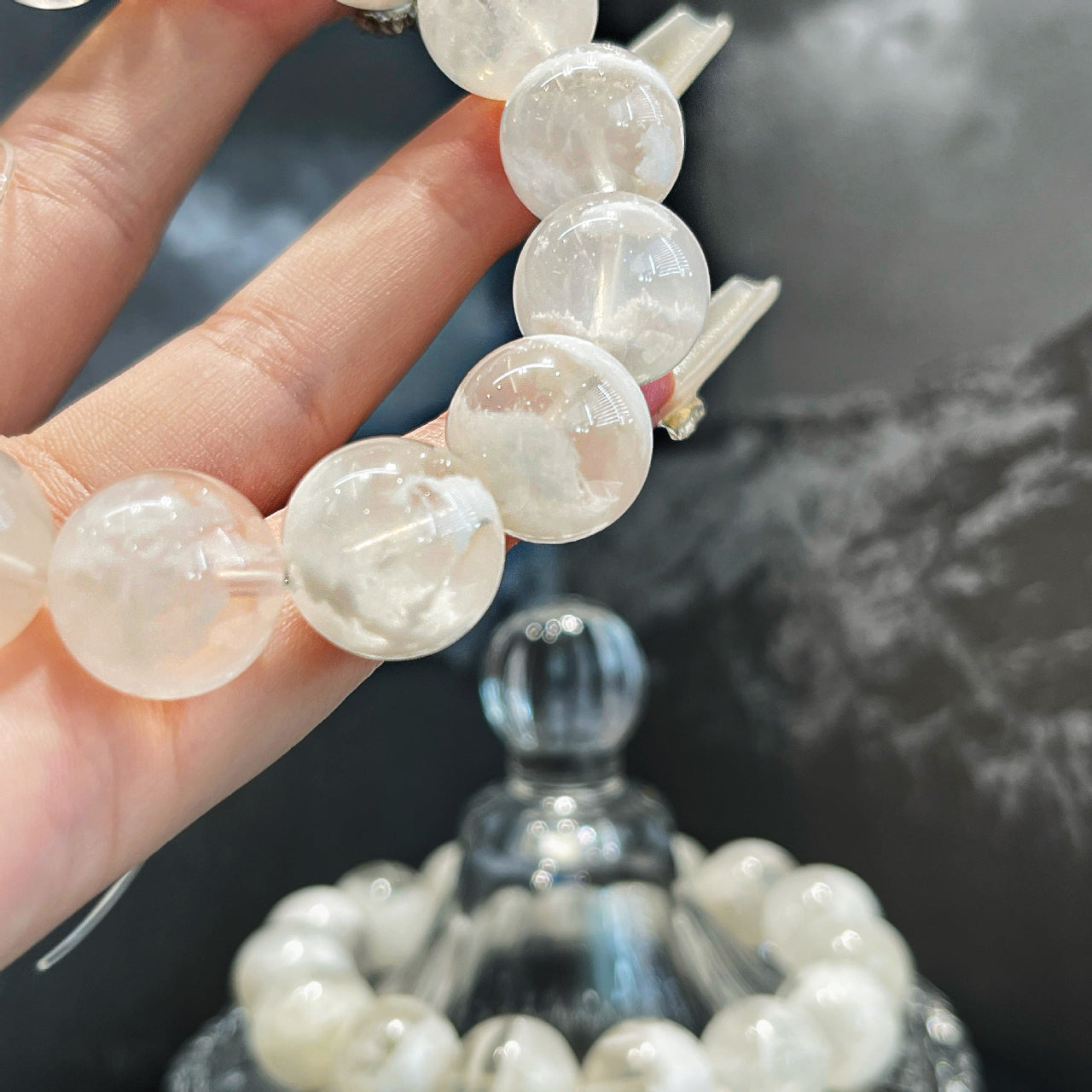 Woman wearing the Snow Veil Bracelet made from premium Snow Phantom Quartz gemstones