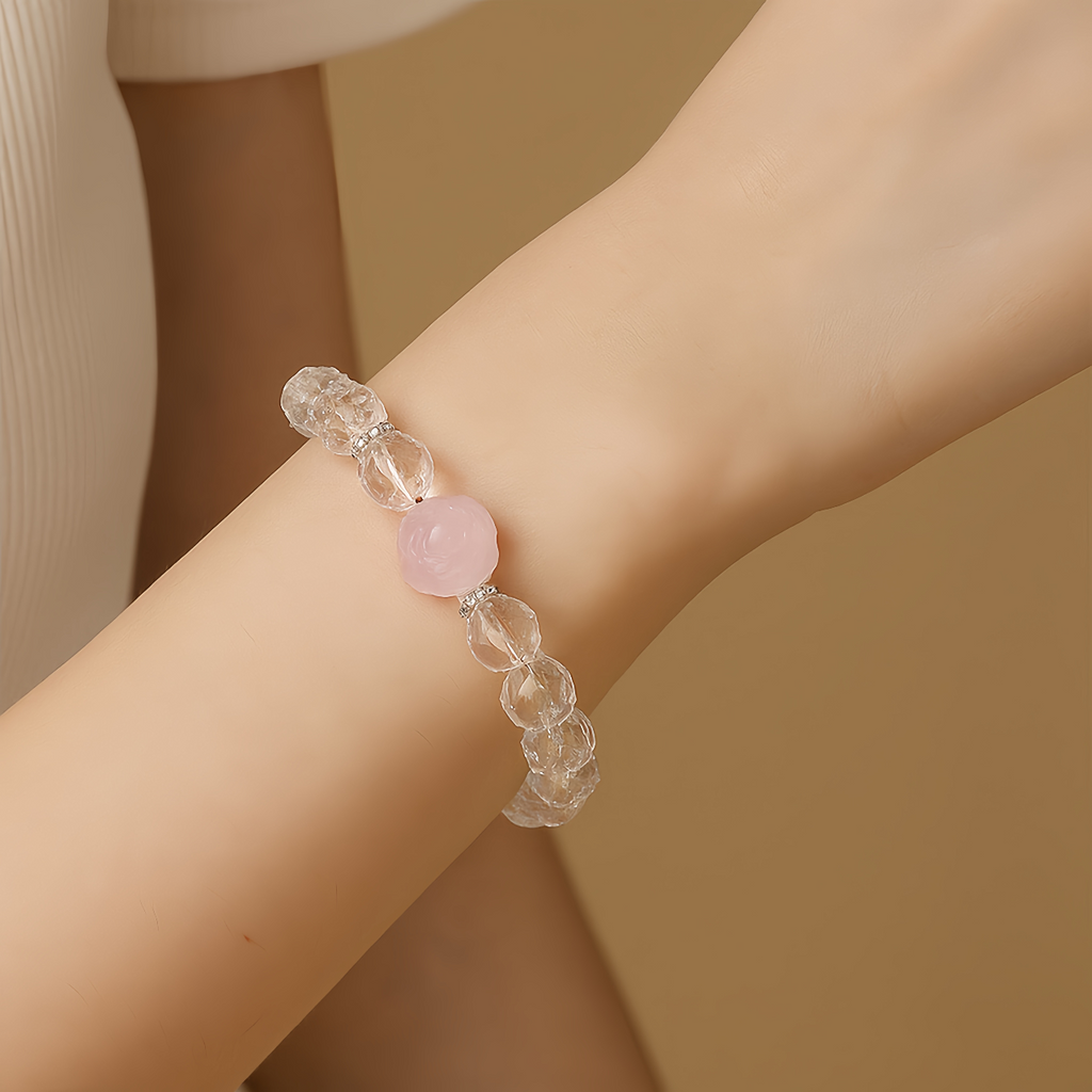 Woman wearing a Sweet Fox Crystal Bracelet with Clear Quartz and Rose Quartz gemstones in a feminine jewelry style